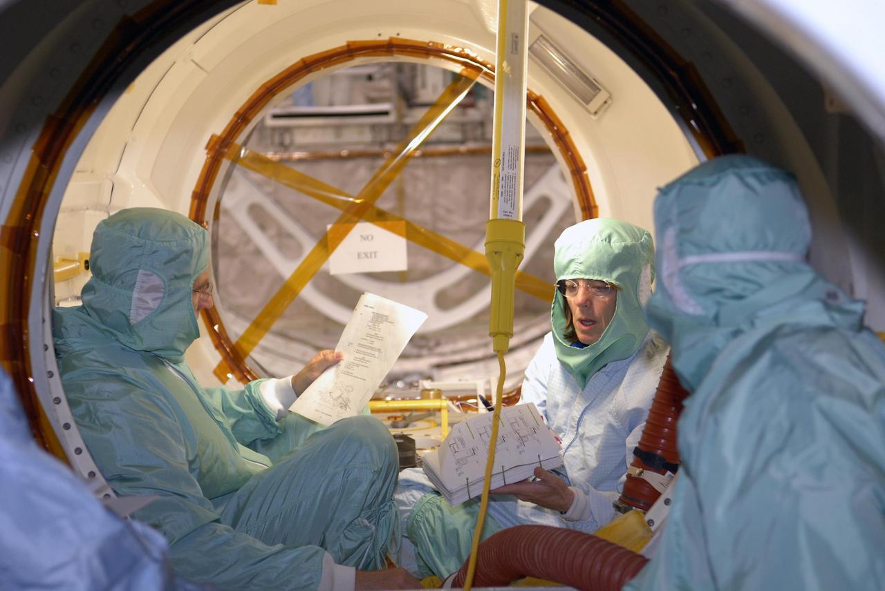 KENNEDY SPACE CENTER, FLA. --   During crew equipment interface test activities at KSC, STS-118 Mission Specialists Dr. Dafydd Williams and Barbara Morgan check data inside the orbiter Endeavour, which is in Orbiter Processing Facility bay 3. The STS-118 mission will be delivering the third starboard truss segment, the ITS S5, to the International Space Station, as well as the SPACEHAB single cargo module filled with supplies and equipment.  Launch aboard Space Shuttle Endeavour is targeted for Aug. 9.   Photo credit: NASA/Kim Shiflett