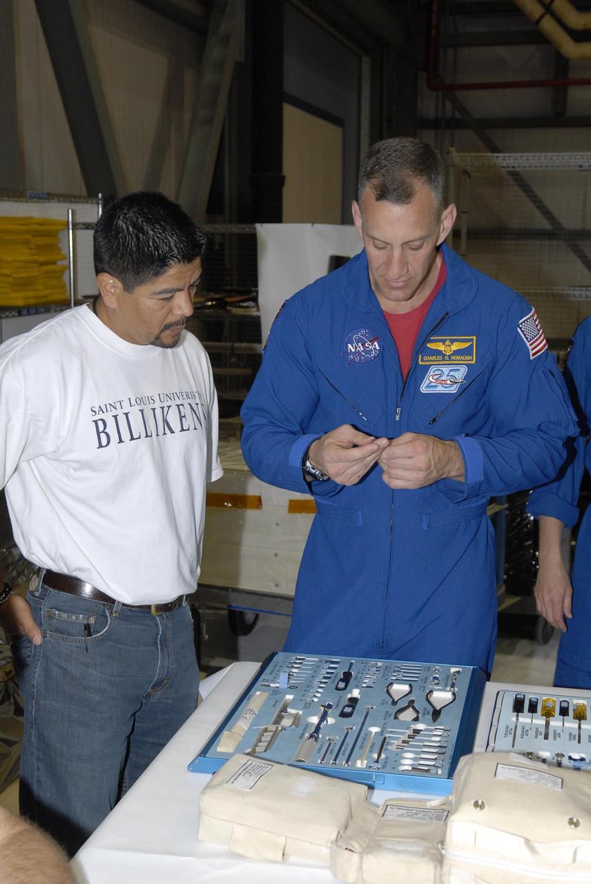 KENNEDY SPACE CENTER, FLA. -- During crew equipment interface test activities in Orbiter Processing Facility bay 3 at KSC, STS-118 crew members get a close look at equipment they will use on their flight.  Seen here is Pilot Charles Hobaugh. The STS-118 mission will be delivering the third starboard truss segment, the ITS S5, to the International Space Station, as well as the SPACEHAB single cargo module filled with supplies and equipment.  Launch aboard Space Shuttle Endeavour is targeted for Aug. 9.   Photo credit: NASA/Kim Shiflett