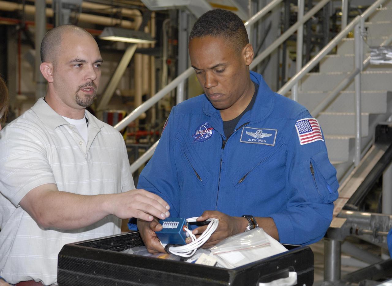 KENNEDY SPACE CENTER, FLA. --   During crew equipment interface test activities in Orbiter Processing Facility bay 3 at KSC, STS-118 Mission Specialist Benjamin Drew gets a close look at equipment that will be used on the flight. The STS-118 mission will be delivering the third starboard truss segment, the ITS S5, to the International Space Station, as well as the SPACEHAB single cargo module filled with supplies and equipment.  Launch aboard Space Shuttle Endeavour is targeted for Aug. 9.   Photo credit: NASA/Kim Shiflett