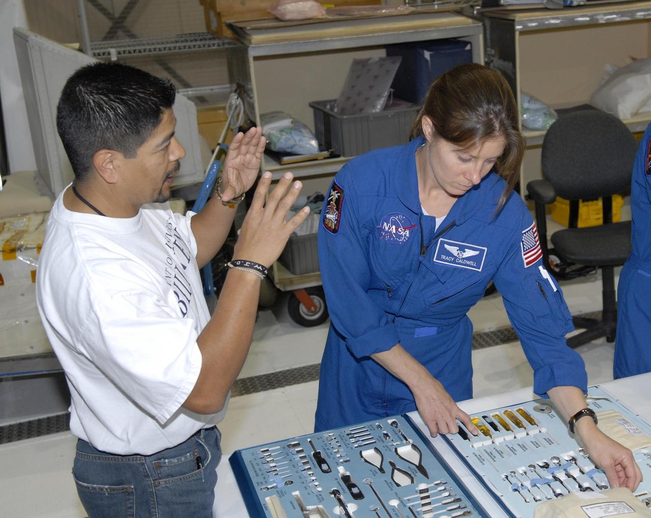 KENNEDY SPACE CENTER, FLA. --  During crew equipment interface test activities in Orbiter Processing Facility bay 3 at KSC, STS-118 Mission Specialist Tracy Caldwell  gets hands-on experience with tools she may use during the flight. The STS-118 mission will be delivering the third starboard truss segment, the ITS S5, to the International Space Station, as well as the SPACEHAB single cargo module filled with supplies and equipment.  Launch aboard Space Shuttle Endeavour is targeted for Aug. 9.   Photo credit: NASA/Kim Shiflett