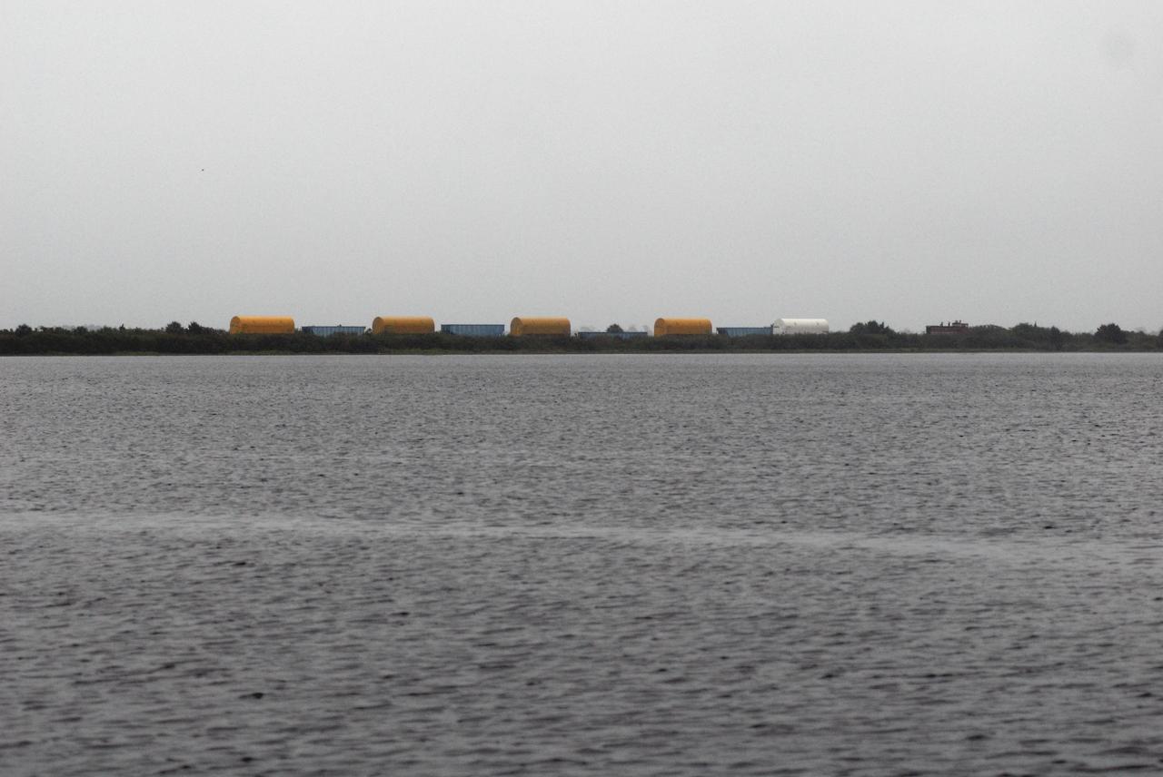 KENNEDY SPACE CENTER, FLA. -- Solid rocket motor segments and two aft exit cone segments arrive by rail at NASA's Kennedy Space Center. While enroute, solid rocket motor segments were involved in a derailment in Alabama. The rail cars carrying these segments remained upright and were undamaged. An inspection determined these segment cars could continue on to Florida. The segments themselves will undergo further evaluation at Kennedy before they are cleared for flight. Other segments involved in the derailment will be returned to a plant in Utah for further evaluation. Photo credit: NASA/Kim Shiflett