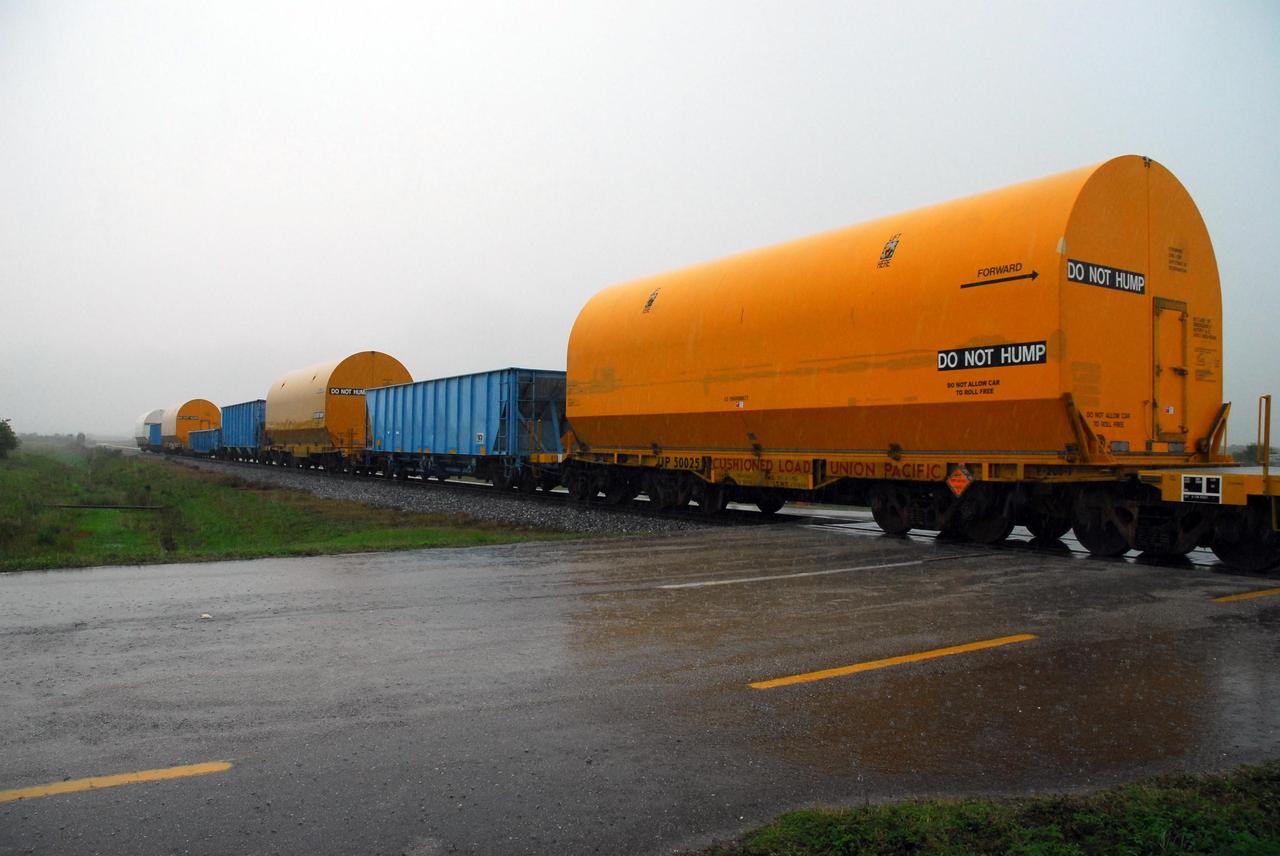 KENNEDY SPACE CENTER, FLA. --   Solid rocket motor segments and two aft exit cone segments arrive by rail at NASA's Kennedy Space Center.  While enroute, solid rocket motor segments were involved in a derailment in Alabama.  The rail cars carrying these segments remained upright and were undamaged.  An inspection determined these segment cars could continue on to Florida.  The segments themselves will undergo further evaluation at Kennedy before they are cleared for flight.  Other segments involved in the derailment will be returned to a plant in Utah for further evaluation.  Photo credit: NASA/George Shelton