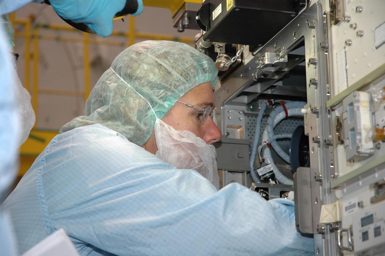 KENNEDY SPACE CENTER, FLA. -- In the Space Station Processing Facility, astronauts are getting first-hand experience with the fluid experiment rack of the Japanese Experiment Module, or JEM, part of the mission payload to the International Space Station. Seen here is Sandra Magnus who will join the Expedition 17 crew on the International Space Station in 2008. The JEM comprises six components: two research facilities -- the Pressurized Module and Exposed Facility; a Logistics Module attached to each of them; a Remote Manipulator System; and an Inter-Orbit Communication System unit. The various components of JEM will be assembled in space over the course of three Space Shuttle missions. The first of those three missions, STS-123, will carry the Experiment Logistics Module Pressurized Section aboard the Space Shuttle Endeavour, targeted for launch in February 2008. Photo credit: NASA/Jim Grossmann