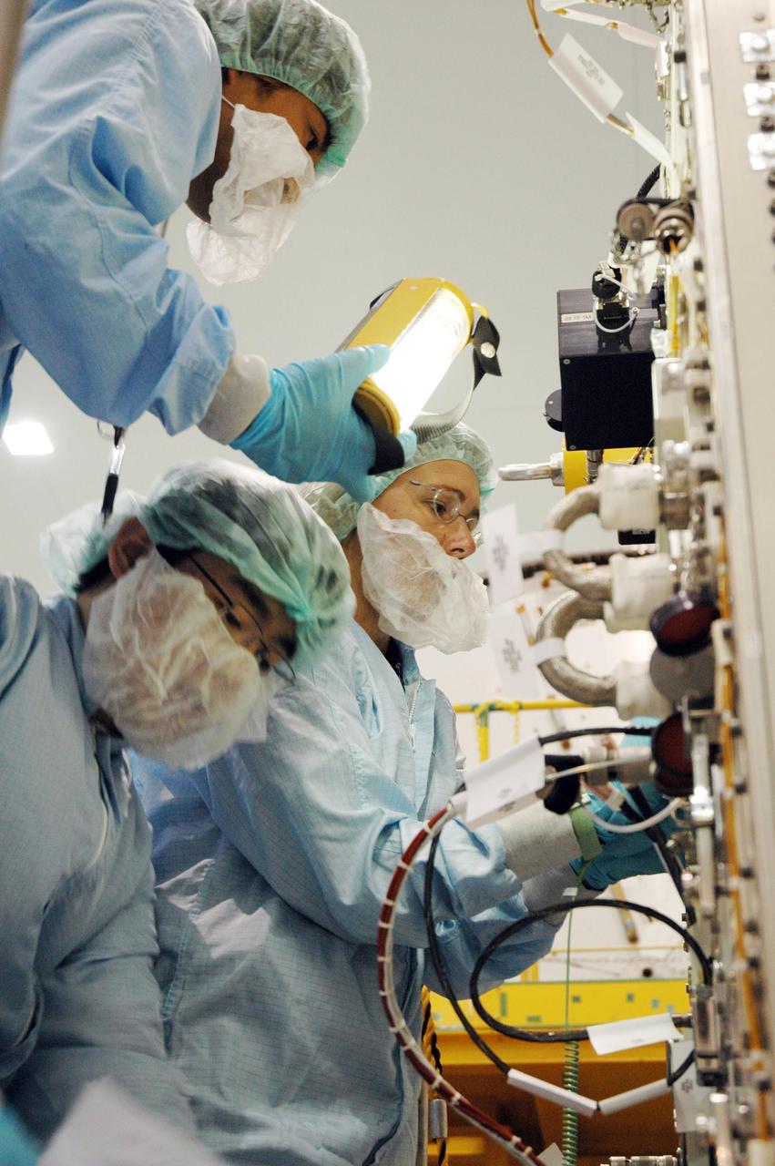 KENNEDY SPACE CENTER, FLA. -- In the Space Station Processing Facility, astronauts are getting first-hand experience with the fluid experiment rack of the Japanese Experiment Module, or JEM, part of the mission payload to the International Space Station. Seen here at right is Sandra Magnus who will join the Expedition 17 crew on the International Space Station in 2008 after the arrival of the JEM. The JEM comprises six components: two research facilities -- the Pressurized Module and Exposed Facility; a Logistics Module attached to each of them; a Remote Manipulator System; and an Inter-Orbit Communication System unit. The various components of JEM will be assembled in space over the course of three Space Shuttle missions. The first of those three missions, STS-123, will carry the Experiment Logistics Module Pressurized Section aboard the Space Shuttle Endeavour, targeted for launch in February 2008. Photo credit: NASA/Jim Grossmann