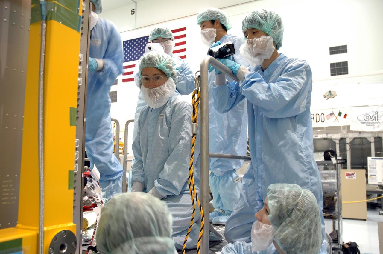 KENNEDY SPACE CENTER, FLA. -- In the Space Station Processing Facility, astronauts are getting first-hand experience with the fluid experiment rack of the Japanese Experiment Module, or JEM, part of the mission payload to the International Space Station. At center is Sandra Magnus who will join the Expedition 17 crew on the International Space Station in 2008 after the arrival of the JEM. The JEM comprises six components: two research facilities -- the Pressurized Module and Exposed Facility; a Logistics Module attached to each of them; a Remote Manipulator System; and an Inter-Orbit Communication System unit. The various components of JEM will be assembled in space over the course of three Space Shuttle missions. The first of those three missions, STS-123, will carry the Experiment Logistics Module Pressurized Section aboard the Space Shuttle Endeavour, targeted for launch in February 2008. Photo credit: NASA/Jim Grossmann