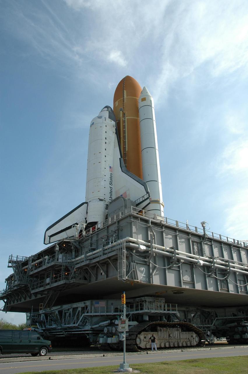 KENNEDY SPACE CENTER, FLA. --   By midmorning, Space Shuttle Atlantis, mounted on a mobile launch platform, nears Launch Pad 39A atop a crawler transporter.  First motion out of the Vehicle Assembly Building was at 5:02 a.m. EDT. In late February, while Atlantis was on the launch pad, Atlantis' external tank received hail damage during a severe thunderstorm that passed through the Kennedy Space Center Launch Complex 39 area. The hail caused visible divots in the giant tank's foam insulation, as well as minor surface damage to about 26 heat shield tiles on the shuttle's left wing. The shuttle was returned to the VAB for repairs. The launch of Space Shuttle Atlantis on mission STS-117 is now targeted for June 8. A flight readiness review will be held on May 30 and 31. Photo credit: NASA/Jim Grossmann