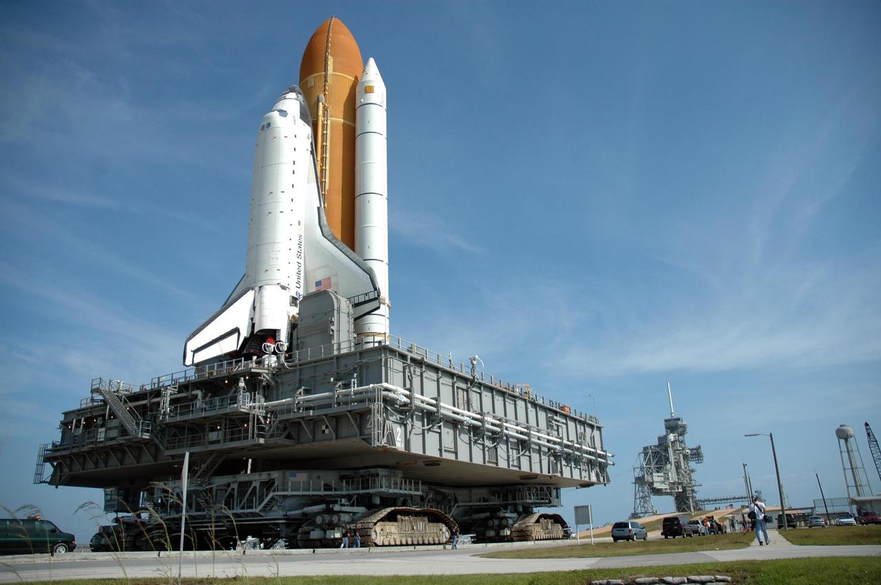 KENNEDY SPACE CENTER, FLA. --  By midmorning, Space Shuttle Atlantis, mounted on a mobile launch platform, nears Launch Pad 39A atop a crawler transporter.  First motion of the shuttle out of the Vehicle Assembly Building was at 5:02 a.m. EDT. In late February, while Atlantis was on the launch pad, Atlantis' external tank received hail damage during a severe thunderstorm that passed through the Kennedy Space Center Launch Complex 39 area. The hail caused visible divots in the giant tank's foam insulation, as well as minor surface damage to about 26 heat shield tiles on the shuttle's left wing. The shuttle was returned to the VAB for repairs. The launch of Space Shuttle Atlantis on mission STS-117 is now targeted for June 8. A flight readiness review will be held on May 30 and 31.  Photo credit: NASA/Jim Grossmann