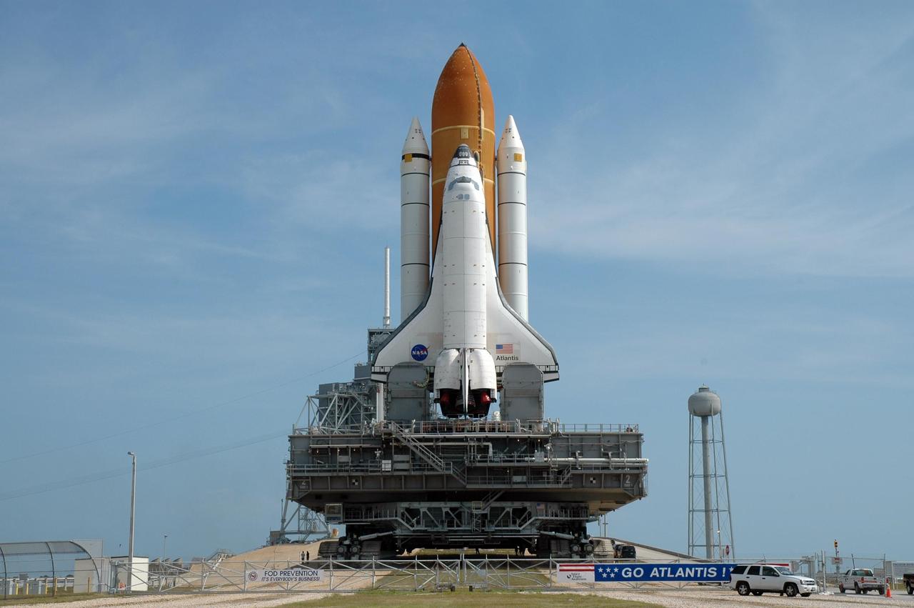KENNEDY SPACE CENTER, FLA. --  Space Shuttle Atlantis, mounted on a mobile launch platform atop a crawler transporter, begins the climb to the top of Launch Pad 39A.  First motion of the shuttle out of the Vehicle Assembly Building was at 5:02 a.m. EDT. In late February, while Atlantis was on the launch pad, Atlantis' external tank received hail damage during a severe thunderstorm that passed through the Kennedy Space Center Launch Complex 39 area. The hail caused visible divots in the giant tank's foam insulation, as well as minor surface damage to about 26 heat shield tiles on the shuttle's left wing. The shuttle was returned to the VAB for repairs. The launch of Space Shuttle Atlantis on mission STS-117 is now targeted for June 8. A flight readiness review will be held on May 30 and 31.  Photo credit: NASA/Jim Grossmann