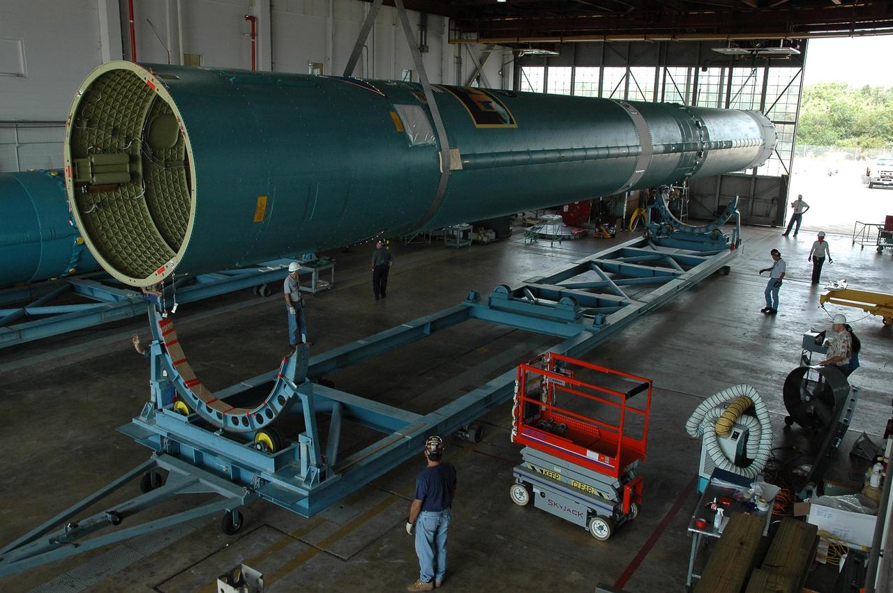 KENNEDY SPACE CENTER, FLA. --  In Hangar M on Cape Canaveral Air Force Station, an overhead crane lifts the Delta II first stage off its stand.  It will be placed onto a transporter for its move to the launch pad.  Dawn's mission is to explore two of the asteroid belt's most intriguing and dissimilar occupants: asteroid Vesta and the dwarf planet Ceres.  Dawn is scheduled to launch June 30 from Launch Complex 17-B.   Photo credit: NASA/Jack Pfaller