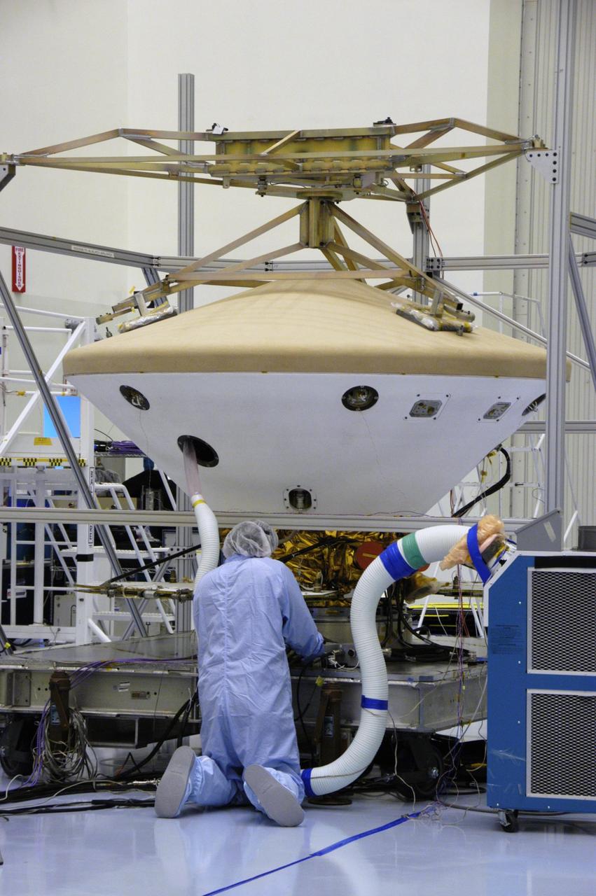 KENNEDY SPACE CENTER, FLA. --   In the Payload Hazardous Servicing Facility, workers prepare to put the Phoenix spacecraft through a heat shield deployment test, with a firing of ordnance associated with the separation device.  Phoenix will land in icy soils near the north polar permanent ice cap of Mars and explore the history of the water in these soils and any associated rocks, while monitoring polar climate.  Landing is planned in May 2008 on arctic ground where a mission currently in orbit, Mars Odyssey, has detected high concentrations of ice just beneath the top layer of soil. Launch of Phoenix aboard a Delta II rocket is targeted for Aug. 3 from Cape Canaveral Air Force Station in Florida.  Photo credit: NASA/George Shelton