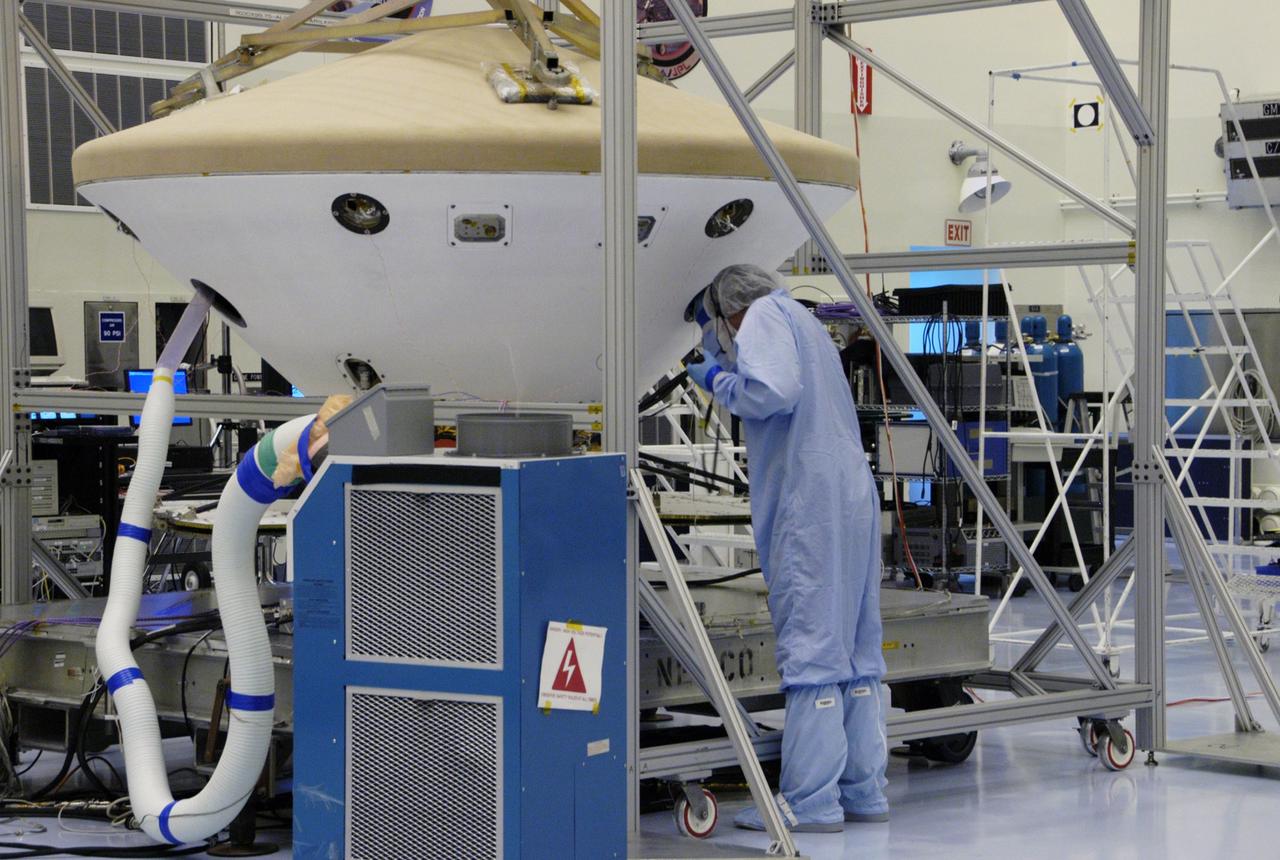 KENNEDY SPACE CENTER, FLA. --  In the Payload Hazardous Servicing Facility, a worker monitors the Phoenix spacecraft during a heat shield deployment test, with a firing of ordnance associated with the separation device.  Phoenix will land in icy soils near the north polar permanent ice cap of Mars and explore the history of the water in these soils and any associated rocks, while monitoring polar climate.  Landing is planned in May 2008 on arctic ground where a mission currently in orbit, Mars Odyssey, has detected high concentrations of ice just beneath the top layer of soil. Launch of Phoenix aboard a Delta II rocket is targeted for Aug. 3 from Cape Canaveral Air Force Station in Florida.  Photo credit: NASA/George Shelton