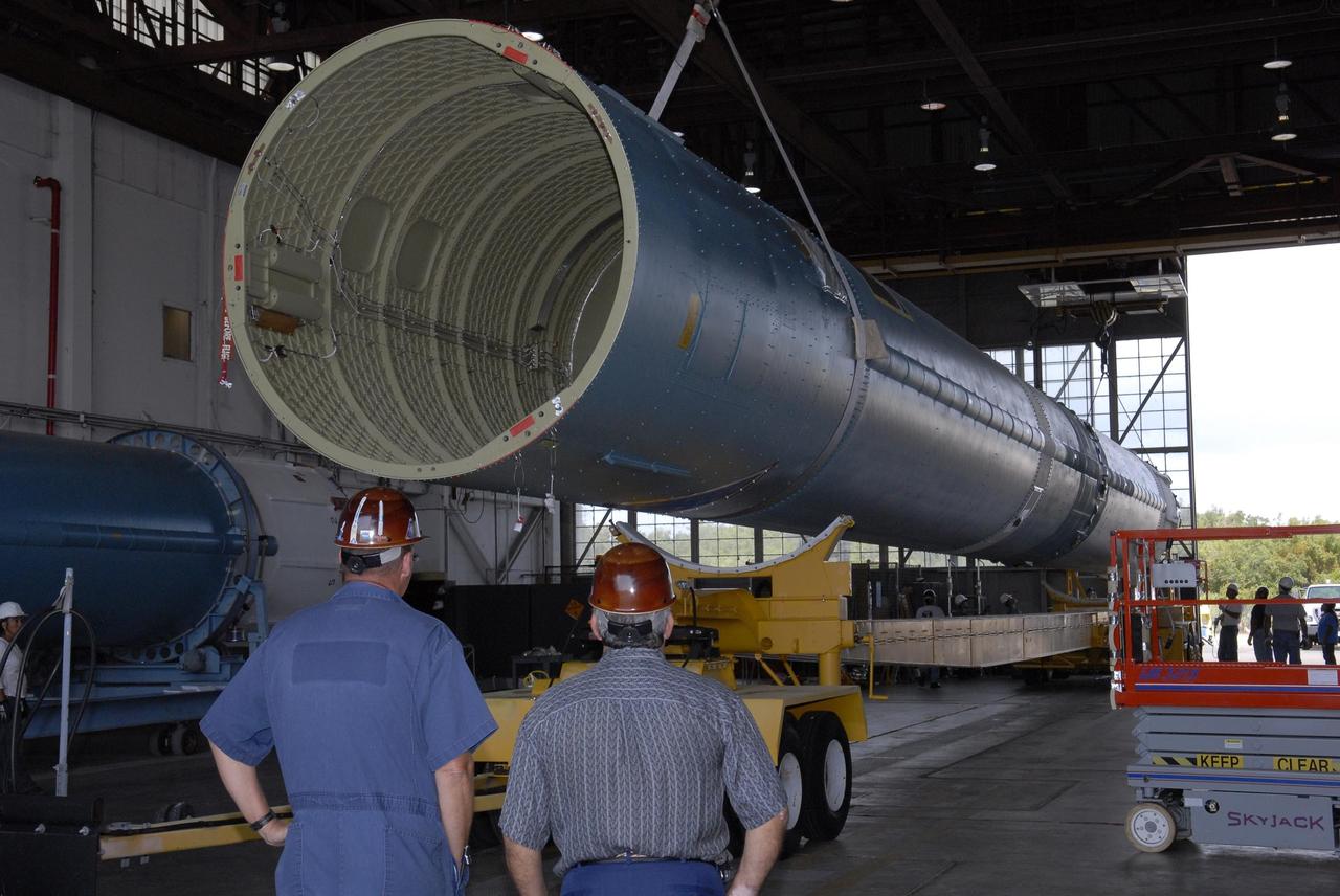 KENNEDY SPACE CENTER, FLA. --   Inside the Hangar M on Cape Canaveral Air Force Station, another Delta II first stage is lowered onto its transporter.  The Delta will be moved to the launch pad for the future launch of a Global Positioning Satellite. Photo credit: NASA/Kim Shiflett