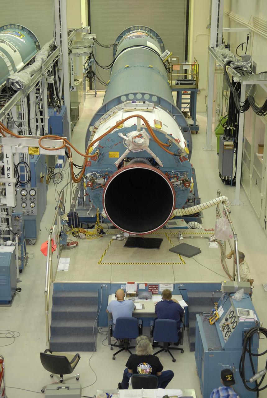 KENNEDY SPACE CENTER, FLA. --   In Hangar A&O on Cape Canaveral Air Force Station in Florida, workers conduct a steering test on the first stage of a Delta II rocket, at right.  The rocket is designated for the launch of the Phoenix Mars Lander spacecraft. Phoenix will land in icy soils near the north polar permanent ice cap of Mars and explore the history of the water in these soils and any associated rocks, while monitoring polar climate. Landing is planned in May 2008 on arctic ground where a mission currently in orbit, Mars Odyssey, has detected high concentrations of ice just beneath the top layer of soil.  Launch of Phoenix is targeted for Aug. 3.  Photo credit: NASA/Kim Shiflett