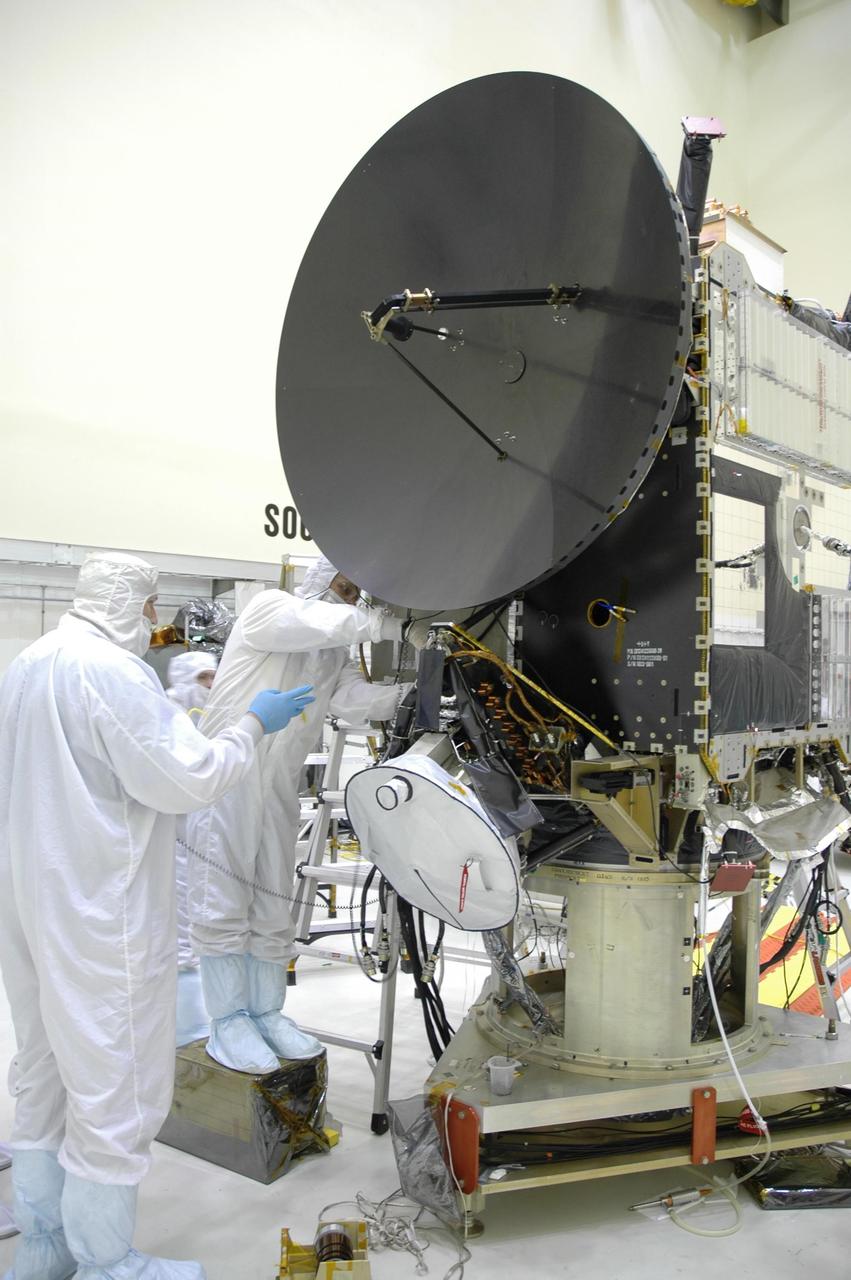 KENNEDY SPACE CENTER, FLA. -- In the Astrotech Space Operations facility, Orbital Science technicians verify that a computer chip is securely bonded to a side brace on the Dawn spacecraft.  The silicon chip holds the names of more than 360,000 space enthusiasts worldwide who signed up to participate in a virtual voyage to the asteroid belt and is about the size of an American five-cent coin. Dawn's mission is to explore two of the asteroid belt's most intriguing and dissimilar occupants: asteroid Vesta and the dwarf planet Ceres. Dawn is scheduled to launch June 30 from Launch Complex 17-B. Photo credit: NASA/George Shelton