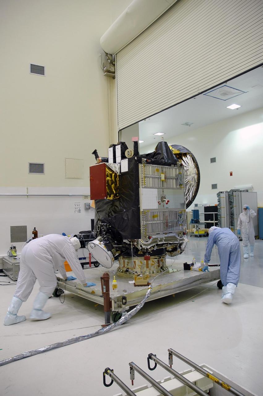 KENNEDY SPACE CENTER, FLA. -- In a clean room at Astrotech, the Dawn spacecraft, secure on a work stand, is moved to another room for solar panel installation.  Dawn's mission is to explore two of the asteroid belt's most intriguing and dissimilar occupants: asteroid Vesta and the dwarf planet Ceres.  Dawn is scheduled to launch June 30 aboard a Delta II rocket from Launch Complex 17-B at Cape Canaveral Air Force Station.    Photo credit: NASA/Jack Pfaller