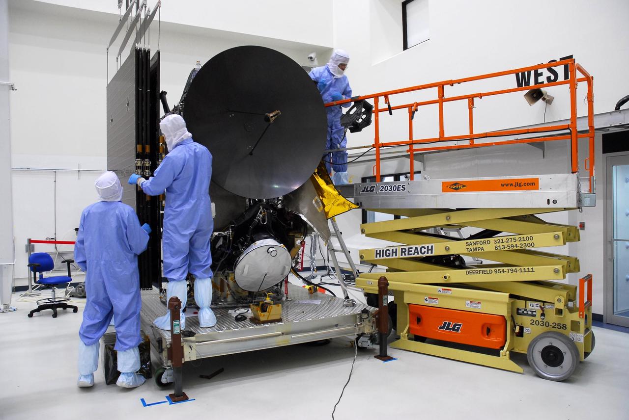KENNEDY SPACE CENTER, FLA. -- At Astrotech, workers get ready to test deploy the large solar array panels on one side of the Dawn spacecraft.  Dawn's mission is to explore two of the asteroid belt's most intriguing and dissimilar occupants: asteroid Vesta and the dwarf planet Ceres.  Dawn is scheduled to launch June 30 aboard a Delta II rocket from Launch Complex 17-B at Cape Canaveral Air Force Station.  Photo credit: NASA/George Shelton