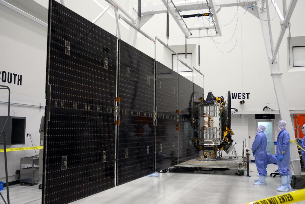 KENNEDY SPACE CENTER, FLA. --  At Astrotech, the more than 32-foot-long solar panels on one side of the Dawn spacecraft are fully deployed during a test.  Dawn's mission is to explore two of the asteroid belt's most intriguing and dissimilar occupants: asteroid Vesta and the dwarf planet Ceres.  Dawn is scheduled to launch June 30 aboard a Delta II rocket from Launch Complex 17-B at Cape Canaveral Air Force Station.  Photo credit: NASA/George Shelton