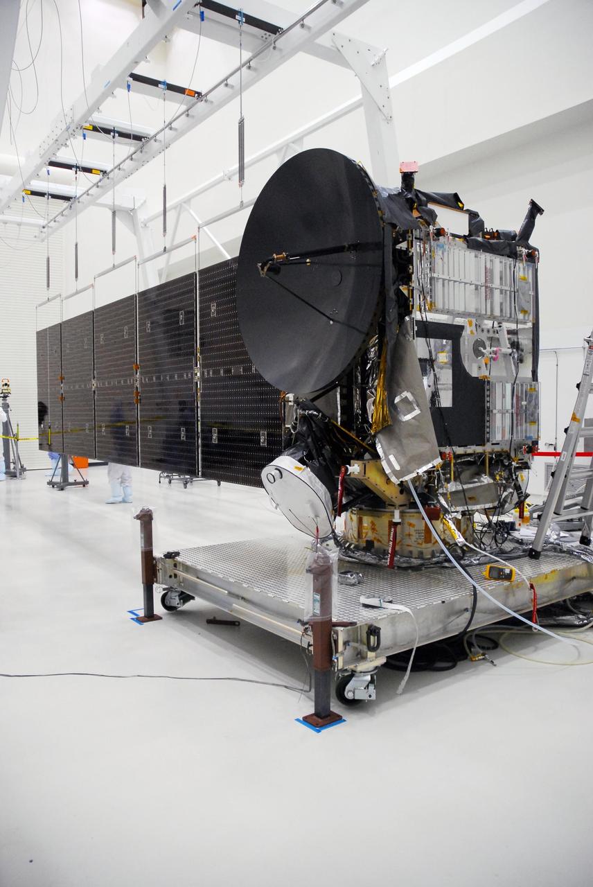 KENNEDY SPACE CENTER, FLA. --  At Astrotech, the more than 32-foot-long solar panels on one side of the Dawn spacecraft are fully deployed during a test. Dawn's mission is to explore two of the asteroid belt's most intriguing and dissimilar occupants: asteroid Vesta and the dwarf planet Ceres.  Dawn is scheduled to launch June 30 aboard a Delta II rocket from Launch Complex 17-B at Cape Canaveral Air Force Station.  Photo credit: NASA/George Shelton