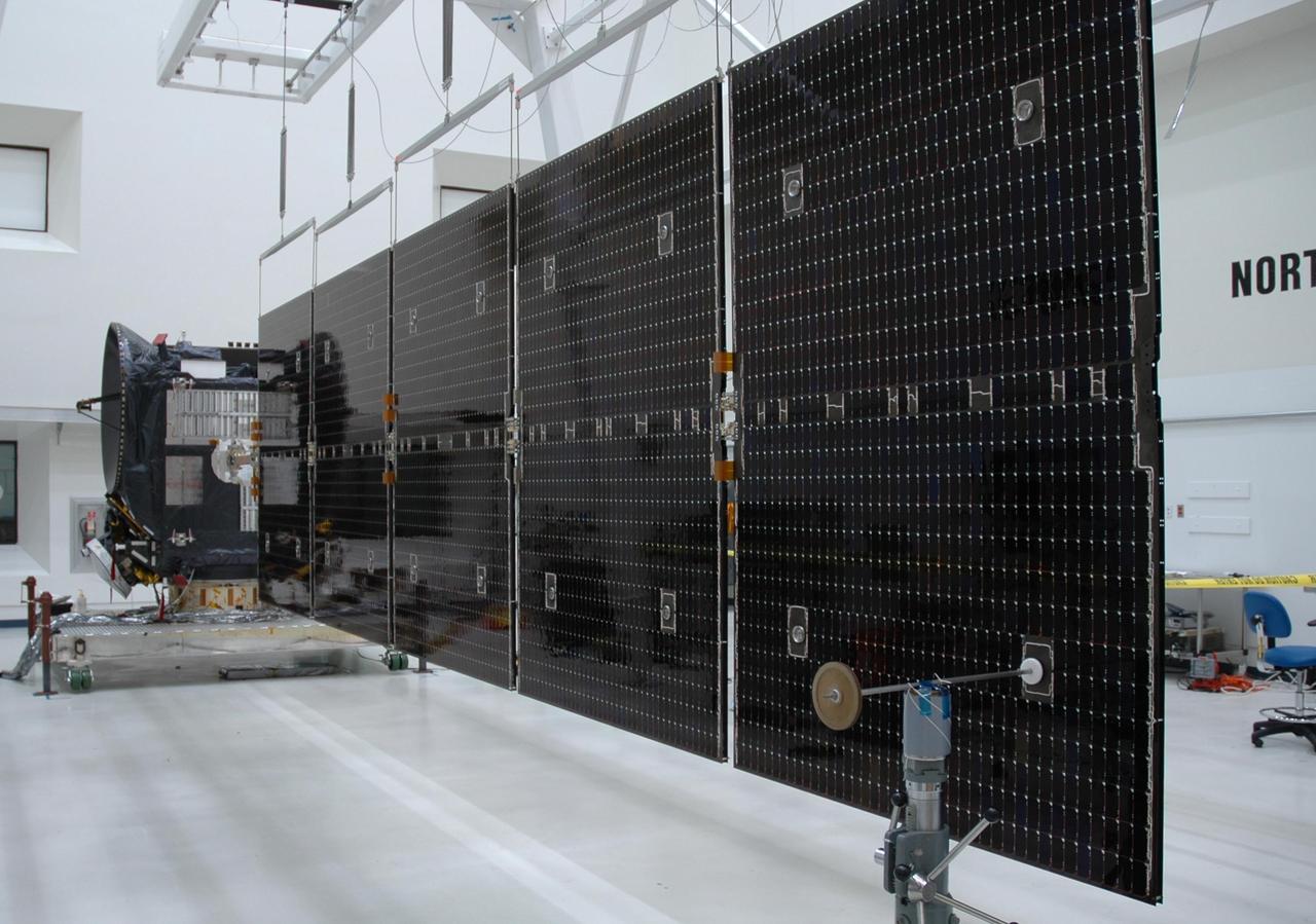 KENNEDY SPACE CENTER, FLA. -- At Astrotech's Payload Processing Facility, the second array of solar panels on the Dawn spacecraft is deployed. After testing, the panels will be stowed and Dawn will be moved to the Hazardous Processing Facility for fueling. Dawn is scheduled to launch June 30 aboard a Delta II rocket from Launch Complex 17-B at Cape Canaveral Air Force Station. Dawn's mission is to explore two of the asteroid belt's most intriguing and dissimilar occupants: asteroid Vesta and the dwarf planet Ceres. Photo credit: NASA/David Lyons-Orbital Sciences