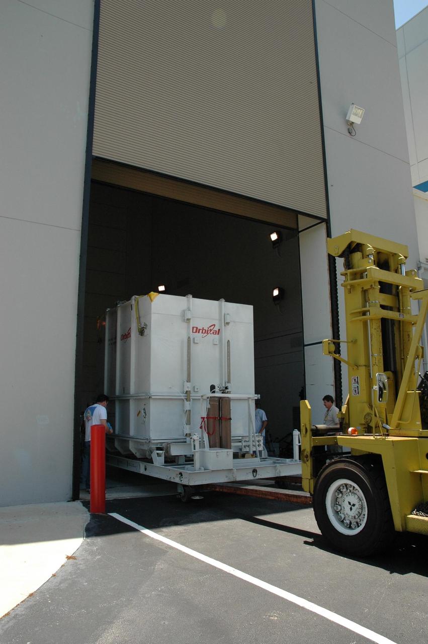 KENNEDY SPACE CENTER, FLA. -- The Dawn spacecraft, inside its shipping container, is moved out of the Astrotech's Payload Processing Facility for transfer to the Hazardous Processing Facility for fueling. Dawn is scheduled to launch June 30 aboard a Delta II rocket from Launch Complex 17-B at Cape Canaveral Air Force Station.  Dawn's mission is to explore two of the asteroid belt's most intriguing and dissimilar occupants: asteroid Vesta and the dwarf planet Ceres. Photo credit: NASA/Charisse Nahser