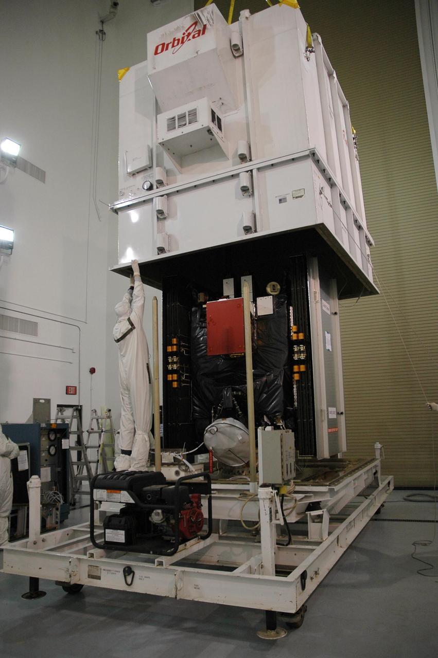 KENNEDY SPACE CENTER, FLA. -- Inside Astrotech's Hazardous Processing Facility, the shipping container is removed from around the Dawn spacecraft.   Dawn will be moved to a scale for weighing and then prepared for fueling.  Dawn is scheduled to launch June 30 aboard a Delta II rocket from Launch Complex 17-B at Cape Canaveral Air Force Station.  Dawn's mission is to explore two of the asteroid belt's most intriguing and dissimilar occupants: asteroid Vesta and the dwarf planet Ceres. Photo credit: NASA/Charisse Nahser