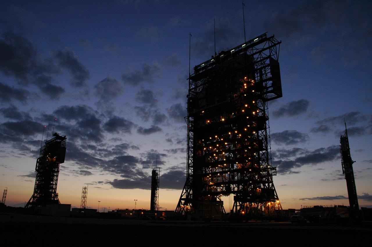 KENNEDY SPACE CENTER, FLA. -- The mobile service towers on Launch Pads 17-A (left) and 17-B (right) are silhouetted against the pre-dawn sky at Cape Canaveral Air Force Station. In the background are the launch gantries. Pad 17-B is the site for the launch of the Dawn spacecraft on June 30. Dawn's mission is to explore two of the asteroid belt's most intriguing and dissimilar occupants: asteroid Vesta and the dwarf planet Ceres. Photo credit: NASA/Amanda Diller