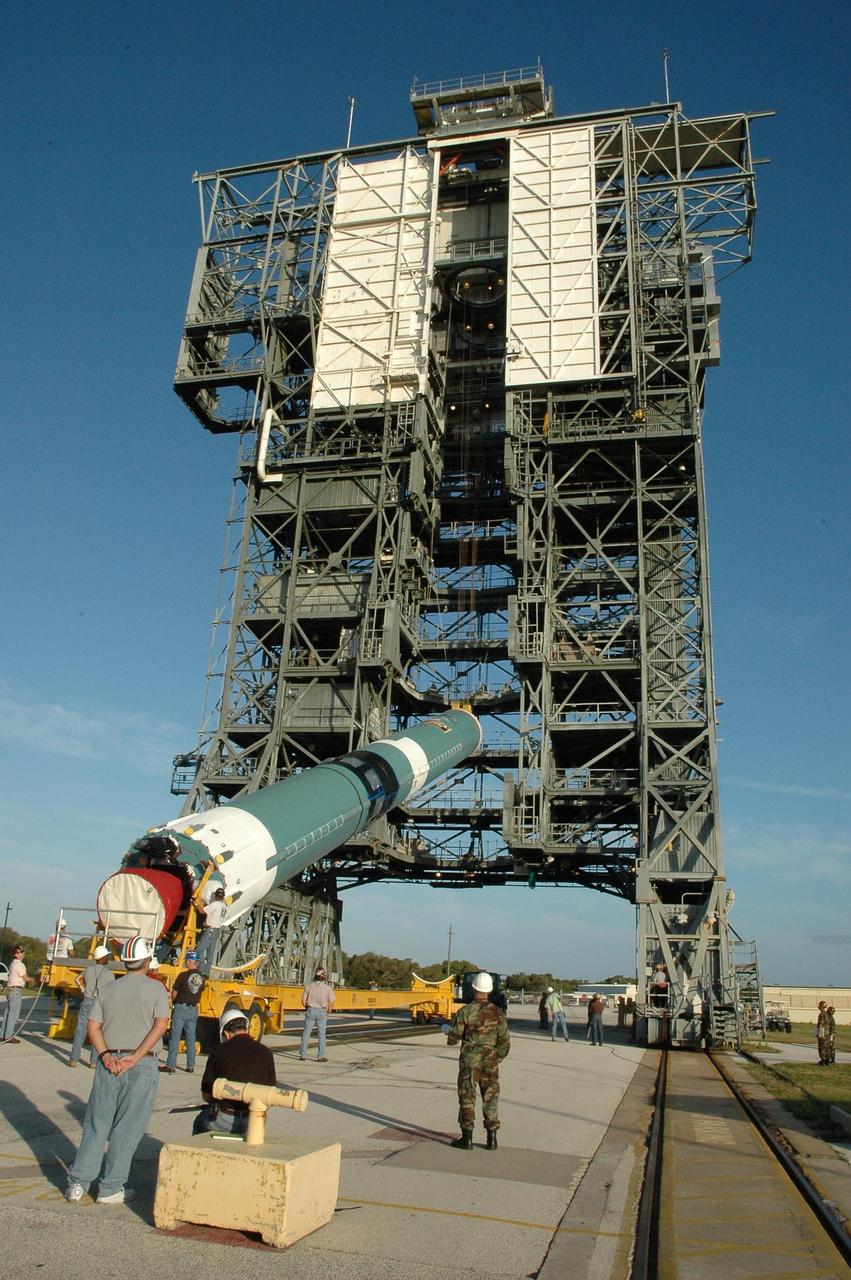 KENNEDY SPACE CENTER, FLA. --  On Launch Pad 17-B at Cape Canaveral Air Force Station, the first stage of a Delta II rocket is being raised off its transporter into a vertical position.  Once vertical, the rocket will be lifted up into the mobile service tower.  The rocket is the launch vehicle for the Dawn spacecraft, targeted for liftoff on June 30.  Dawn's mission is to explore two of the asteroid belt's most intriguing and dissimilar occupants: asteroid Vesta and the dwarf planet Ceres.   Photo credit: NASA/Amanda Diller