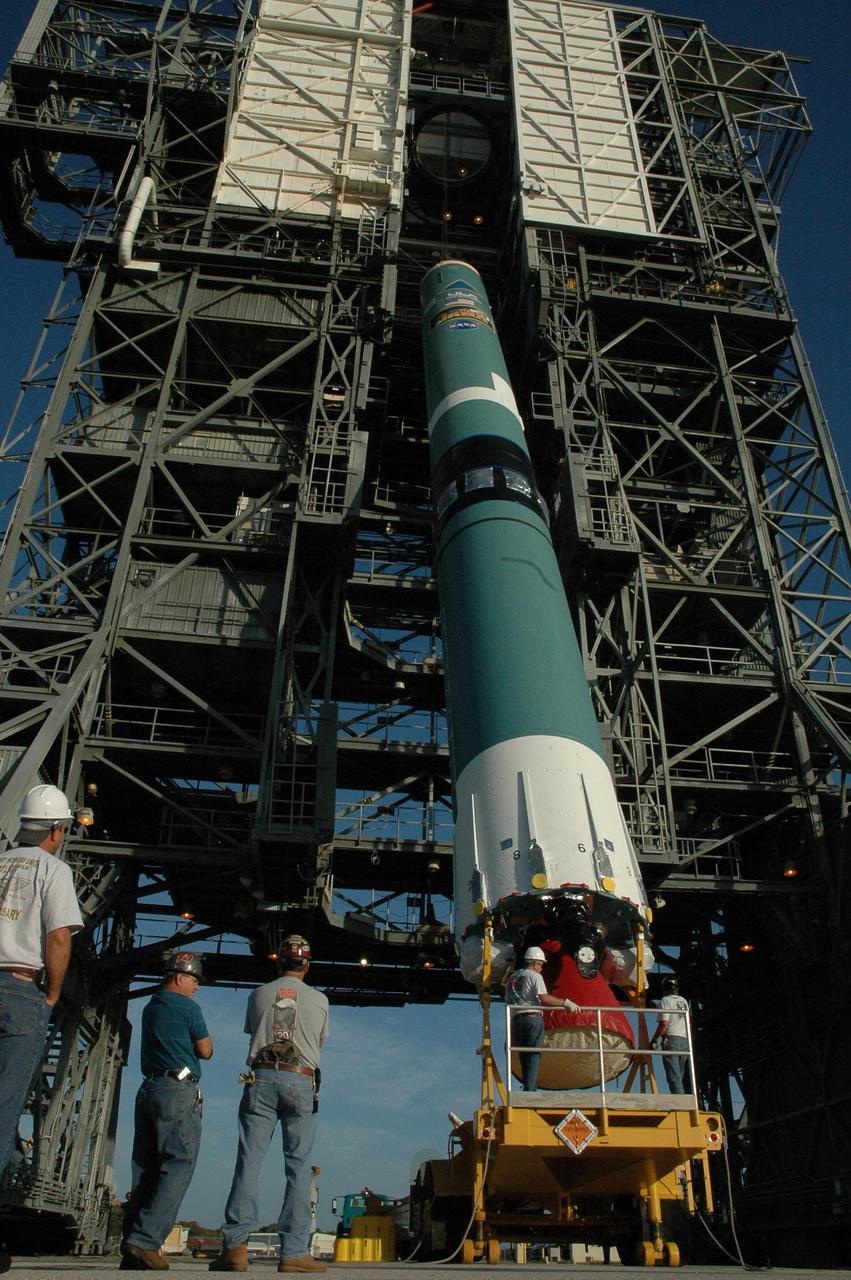 KENNEDY SPACE CENTER, FLA. --  On Launch Pad 17-B at Cape Canaveral Air Force Station, the first stage of a Delta II rocket is being raised to a vertical position before being lifted into the mobile service tower.  The rocket is the launch vehicle for the Dawn spacecraft, targeted for liftoff on June 30.  Dawn's mission is to explore two of the asteroid belt's most intriguing and dissimilar occupants: asteroid Vesta and the dwarf planet Ceres.   Photo credit: NASA/Amanda Diller