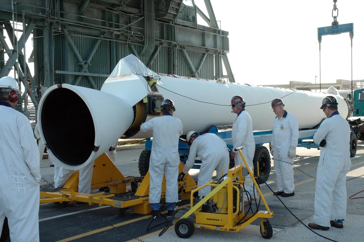 KENNEDY SPACE CENTER, FLA. -- On Launch Pad 17-B at Cape Canaveral Air Force Station, workers prepare the solid rocket booster to be raised off the transporter. The SRB is one of nine to be mated to the Delta II rocket that will launch the Dawn spacecraft. Dawn's mission is to explore two of the asteroid belt's most intriguing and dissimilar occupants: asteroid Vesta and the dwarf planet Ceres. Photo credit: NASA/Jim Grossmann