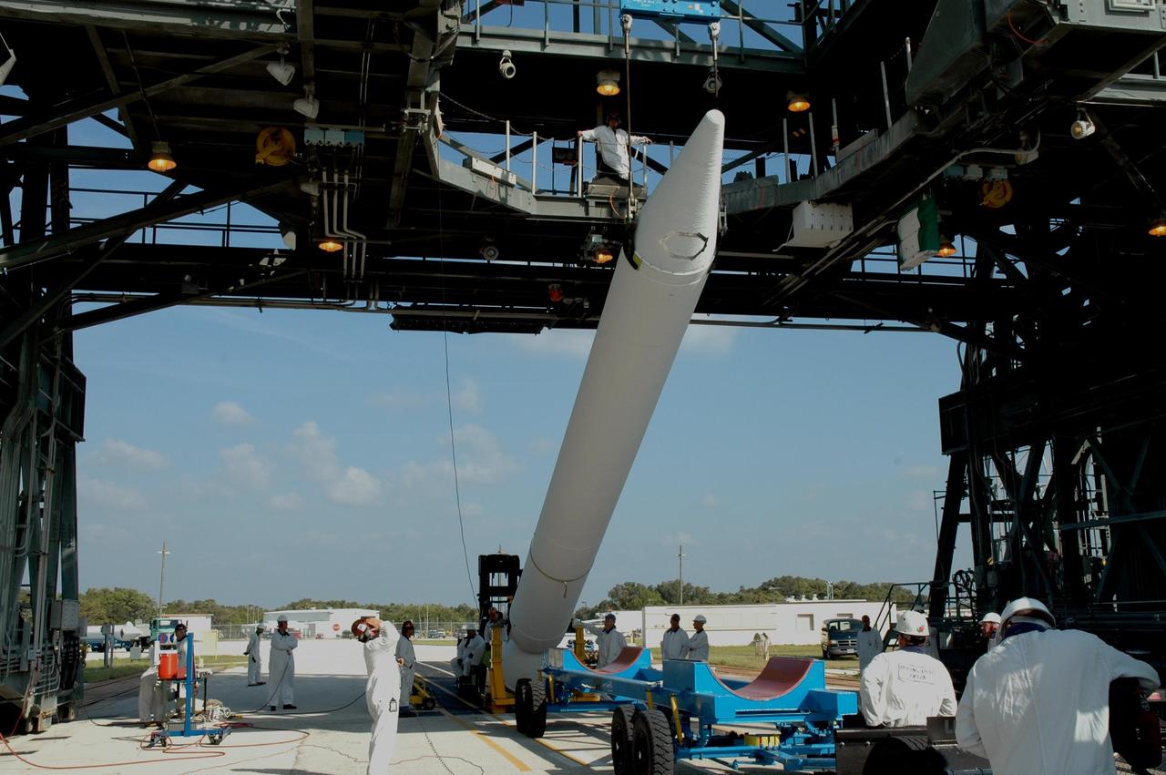 KENNEDY SPACE CENTER, FLA. -- On Launch Pad 17-B at Cape Canaveral Air Force Station, one of nine solid rocket boosters is raised off the transporter. It will be lifted into the mobile service tower for attachment around the Delta II first stage. The SRB is one of nine to be attached for the launch of the Dawn spacecraft. Dawn's mission is to explore two of the asteroid belt's most intriguing and dissimilar occupants: asteroid Vesta and the dwarf planet Ceres. Photo credit: NASA/Jim Grossmann