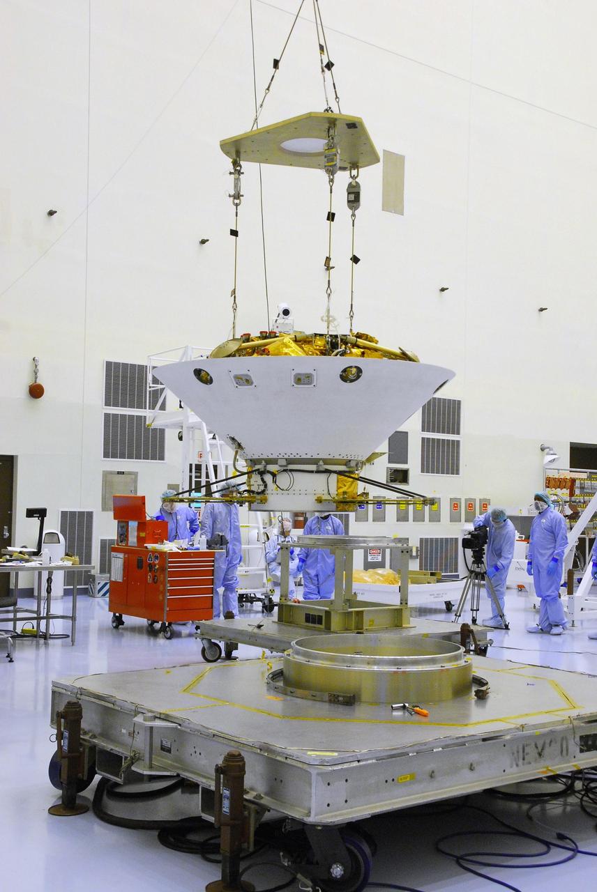 KENNEDY SPACE CENTER, FLA. -- An overhead crane lifts the Phoenix spacecraft from its stand for a move to a rotation stand for an interim weight and center of gravity determination. The Phoenix mission is the first project in NASA's first openly competed program of Mars Scout missions. Phoenix will land in icy soils near the north polar permanent ice cap of Mars and explore the history of the water in these soils and any associated rocks, while monitoring polar climate. Landing is planned in May 2008 on arctic ground where a mission currently in orbit, Mars Odyssey, has detected high concentrations of ice just beneath the top layer of soil. It will serve as NASA's first exploration of a potential modern habitat on Mars and open the door to a renewed search for carbon-bearing compounds, Photo credit: NASA/George Shelton