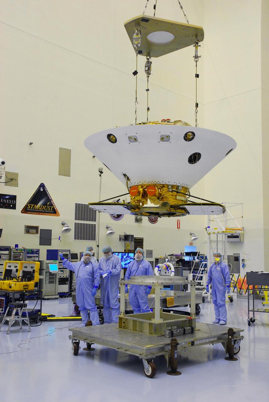 KENNEDY SPACE CENTER, FLA. -- In the Payload Handling Servicing Facility, an overhead crane lifts the Phoenix spacecraft from its stand for a move to a rotation stand for an interim weight and center of gravity determination. The Phoenix mission is the first project in NASA's first openly competed program of Mars Scout missions. Phoenix will land in icy soils near the north polar permanent ice cap of Mars and explore the history of the water in these soils and any associated rocks, while monitoring polar climate. Landing is planned in May 2008 on arctic ground where a mission currently in orbit, Mars Odyssey, has detected high concentrations of ice just beneath the top layer of soil. It will serve as NASA's first exploration of a potential modern habitat on Mars and open the door to a renewed search for carbon-bearing compounds, Photo credit: NASA/George Shelton