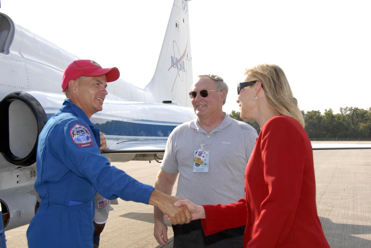 KENNEDY SPACE CENTER, FLA. --  The STS-117 crew members arrive at the KSC Shuttle Landing Facility aboard T-38 jet aircraft to prepare for launch on Space Shuttle Atlantis on June 8.  Commander Frederick Sturckow is greeted by Janet Petro, deputy director of Kennedy. Astronaut Jerry Ross, chief of the Vehicle Integration Test Office at Johnson Space Center, looks on.  During the 11-day mission and three spacewalks, the crew will work with flight controllers at NASA's Johnson Space Center in Houston to install a 17-ton segment on the station's girder-like truss and deploy a set of solar arrays, S3/S4. The mission will increase the space station's power capability in preparation for the arrival of new science modules from the European and Japanese space agencies.    Photo credit: NASA/Kim Shiflett