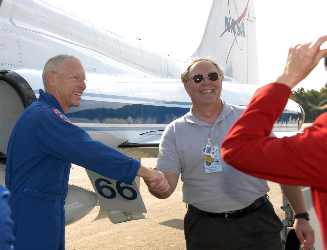KENNEDY SPACE CENTER, FLA. --  The STS-117 crew members arrive at the KSC Shuttle Landing Facility aboard T-38 jet aircraft to prepare for launch on Space Shuttle Atlantis on June 8.  Mission Specialist Patrick Forrester is welcomed by astronaut Jerry Ross, chief of the Vehicle Integration Test Office at Johnson Space Center.  During the 11-day mission and three spacewalks, the crew will work with flight controllers at NASA's Johnson Space Center in Houston to install a 17-ton segment on the station's girder-like truss and deploy a set of solar arrays, S3/S4. The mission will increase the space station's power capability in preparation for the arrival of new science modules from the European and Japanese space agencies.    Photo credit: NASA/Kim Shiflett