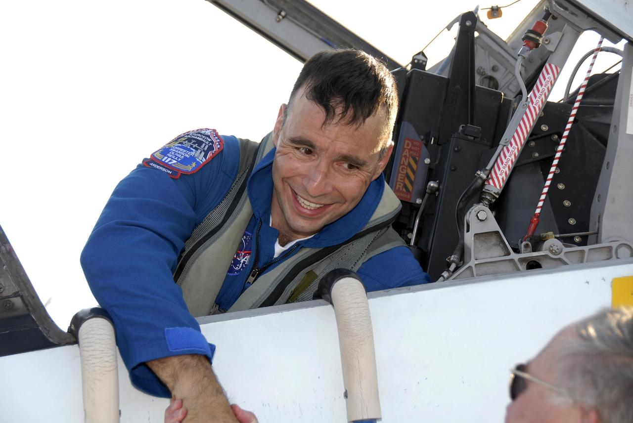 KENNEDY SPACE CENTER, FLA. -- The STS-117 crew members arrive at the KSC Shuttle Landing Facility aboard T-38 jet aircraft to prepare for launch on Space Shuttle Atlantis on June 8.  Still in the plane, Pilot Lee Archambault is greeted by astronaut Jerry Ross, chief of the Vehicle Integration Test Office at Johnson Space Center.  During the 11-day mission and three spacewalks, the crew will work with flight controllers at NASA's Johnson Space Center in Houston to install a 17-ton segment on the station's girder-like truss and deploy a set of solar arrays, S3/S4. The mission will increase the space station's power capability in preparation for the arrival of new science modules from the European and Japanese space agencies.    Photo credit: NASA/Kim Shiflett