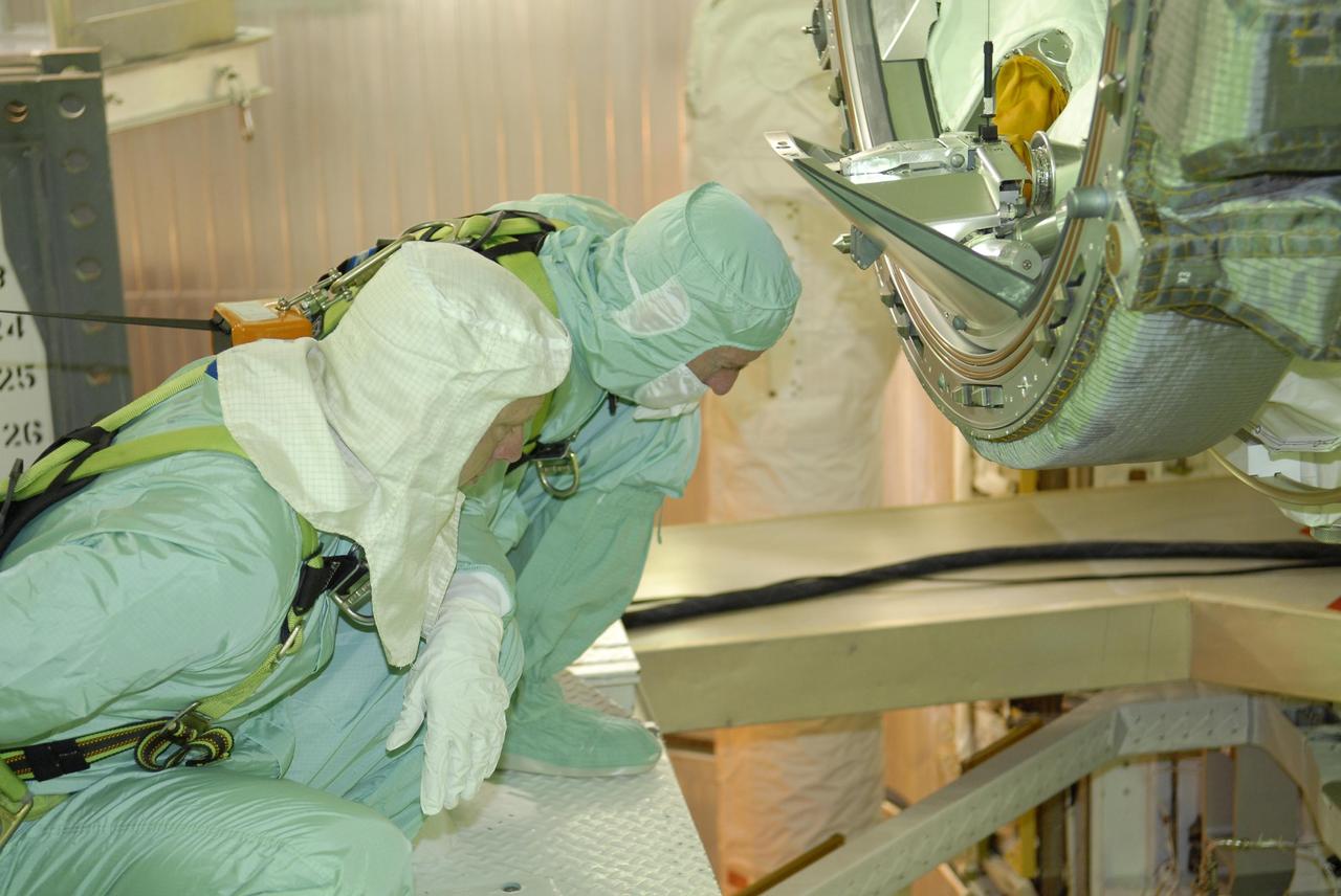 KENNEDY SPACE CENTER, FLA. -- After their arrival at KSC, STS-117 crew members take part in a payload bay walkdown on Launch Pad 39A to look at the cargo in Space Shuttle Atlantis.  Seen here are Mission Specialists Patrick Forrester (left) and James Reilly.  The payload includes the S3/S4 integrated truss structure for the International Space Station.  STS-117 is scheduled to launch at 7:38 p.m. June 8.  During the 11-day mission and three spacewalks, the crew will work with flight controllers at NASA's Johnson Space Center in Houston to install the 17-ton segment on the station's girder-like truss and deploy the set of solar arrays, S3/S4. The mission will increase the space station's power capability in preparation for the arrival of new science modules from the European and Japanese space agencies.    Photo credit: NASA/Kim Shiflett