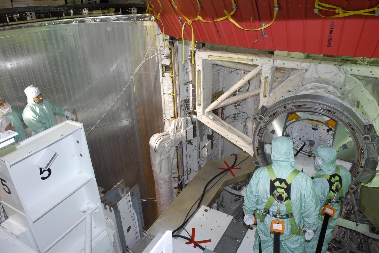 KENNEDY SPACE CENTER, FLA. --  After their arrival at KSC, STS-117 crew members take part in a payload bay walkdown on Launch Pad 39A to look at the cargo in Space Shuttle Atlantis. The payload includes the S3/S4 integrated truss structure for the International Space Station. STS-117 is scheduled to launch at 7:38 p.m. June 8.  During the 11-day mission and three spacewalks, the crew will work with flight controllers at NASA's Johnson Space Center in Houston to install the 17-ton segment on the station's girder-like truss and deploy the set of solar arrays, S3/S4. The mission will increase the space station's power capability in preparation for the arrival of new science modules from the European and Japanese space agencies.    Photo credit: NASA/Kim Shiflett