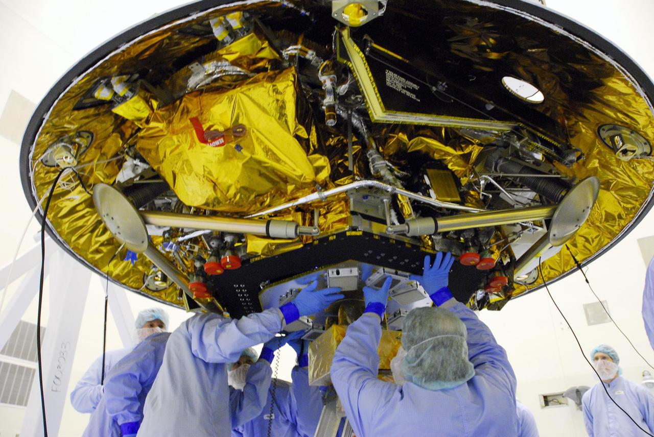 KENNEDY SPACE CENTER, FLA. -- At the Payload Hazardous Servicing Facility, workers integrate the landing radar with the Phoenix spacecraft. Testing will follow. The Phoenix mission is the first project in NASA's first openly competed program of Mars Scout missions. Phoenix will land in icy soils near the north polar permanent ice cap of Mars and explore the history of the water in these soils and any associated rocks, while monitoring polar climate. Landing is planned in May 2008 on arctic ground where a mission currently in orbit, Mars Odyssey, has detected high concentrations of ice just beneath the top layer of soil. Photo credit: NASA/George Shelton