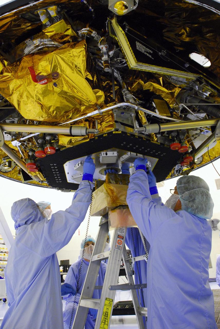 KENNEDY SPACE CENTER, FLA. -- At the Payload Hazardous Servicing Facility, workers integrate the landing radar with the Phoenix spacecraft. Testing will follow. The Phoenix mission is the first project in NASA's first openly competed program of Mars Scout missions. Phoenix will land in icy soils near the north polar permanent ice cap of Mars and explore the history of the water in these soils and any associated rocks, while monitoring polar climate. Landing is planned in May 2008 on arctic ground where a mission currently in orbit, Mars Odyssey, has detected high concentrations of ice just beneath the top layer of soil. Photo credit: NASA/George Shelton