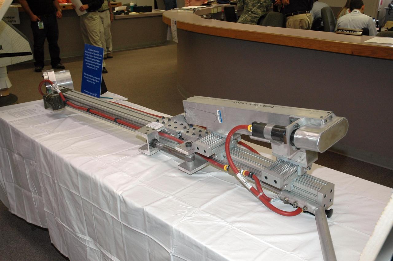 KENNEDY SPACE CENTER, FLA. --  The "pencil sharpener" tool designed to trim the hand-sprayed foam repairs on the STS-117 external tank is on display for the media at the NASA News Center. This portable tool was designed in just 10 days specifically for this task by Lockheed Martin engineer Glenn Lapeyronnie at the Michoud external tank manufacturing facility in New Orleans. The pencil sharpener tool fits over the external tank nose cone spike at the top of the tank and extends down to where the hand-sprayed foam was used to repair the hail-damaged areas. The hail damage was incurred Feb. 28 while Space Shuttle Atlantis was on the launch pad for a March 15 launch.  The shuttle returned to the Vehicle Assembly Building so that repairs could be made.  Mission STS-117 is scheduled to launch at 7:38 p.m. EDT on June 8.   Photo credit: NASA/Jack Pfaller