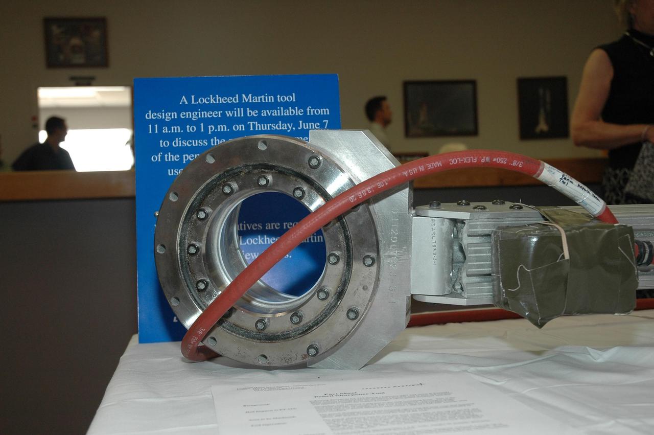 KENNEDY SPACE CENTER, FLA. --  The "pencil sharpener" tool designed to trim the hand-sprayed foam repairs on the STS-117 external tank is on display for the media at the NASA News Center. This portable tool was designed in just 10 days specifically for this task by Lockheed Martin engineer Glenn Lapeyronnie at the Michoud external tank manufacturing facility in New Orleans. The pencil sharpener tool fits over the external tank nose cone spike at the top of the tank and extends down to where the hand-sprayed foam was used to repair the hail-damaged areas. The hail damage was incurred Feb. 28 while Space Shuttle Atlantis was on the launch pad for a March 15 launch.  The shuttle returned to the Vehicle Assembly Building so that repairs could be made.  Mission STS-117 is scheduled to launch at 7:38 p.m. EDT on June 8.   Photo credit: NASA/Jack Pfaller