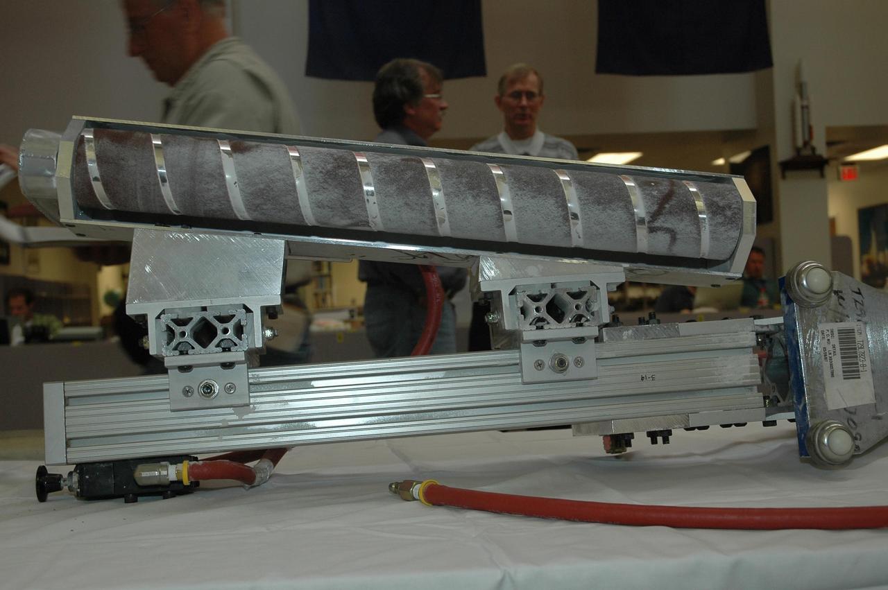 KENNEDY SPACE CENTER, FLA. --  The "pencil sharpener" tool designed to trim the hand-sprayed foam repairs on the STS-117 external tank is on display for the media at the NASA News Center. This portable tool was designed in just 10 days specifically for this task by Lockheed Martin engineer Glenn Lapeyronnie at the Michoud external tank manufacturing facility in New Orleans. The pencil sharpener tool fits over the external tank nose cone spike at the top of the tank and extends down to where the hand-sprayed foam was used to repair the hail-damaged areas. The hail damage was incurred Feb. 28 while Space Shuttle Atlantis was on the launch pad for a March 15 launch.  The shuttle returned to the Vehicle Assembly Building so that repairs could be made.  Mission STS-117 is scheduled to launch at 7:38 p.m. EDT on June 8.   Photo credit: NASA/Jack Pfaller