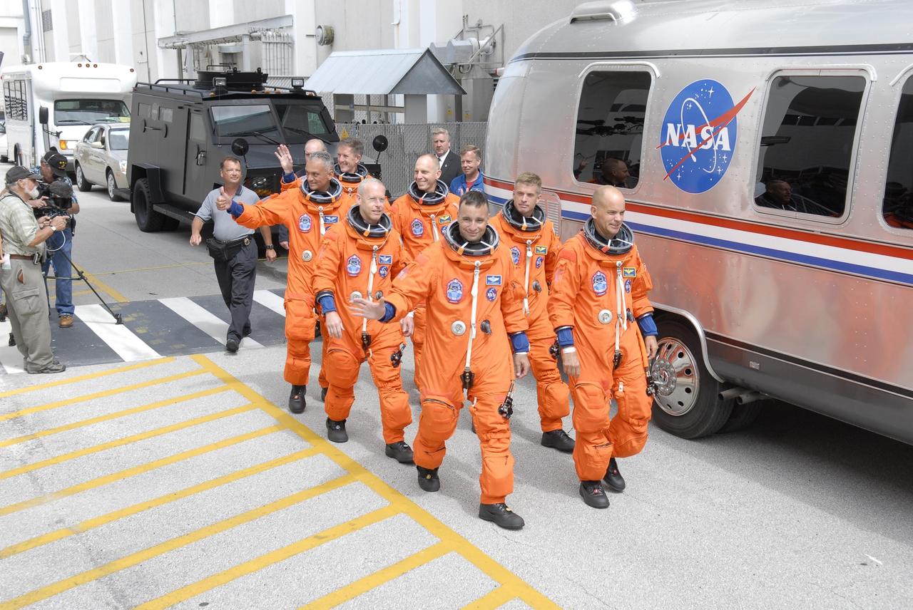 KENNEDY SPACE CENTER, FLA. -- The STS-117 crew members head for the astrovan that will take them to Launch Pad 39A. From left are Mission Specialists John "Danny" Olivas, James Reilly and Patrick Forrester; astronaut Clayton Anderson; Pilot Lee Archambault; Mission Specialist Steven Swanson; and Commander Frederick Sturckow. Anderson is joining the Expedition 15 crew on the International Space Station; Flight Engineer Suni Williams will return to Earth in his place. Liftoff is scheduled for 7:38 p.m. today aboard Space Shuttle Atlantis. The shuttle is delivering a new segment to the starboard side of the International Space Station's backbone, known as the truss. Three spacewalks are planned to install the S3/S4 truss segment, deploy a set of solar arrays and prepare them for operation. STS-117 is the 118th space shuttle flight, the 21st flight to the station, the 28th flight for Atlantis and the first of four flights planned for 2007. Photo credit: NASA/Kim Shiflett