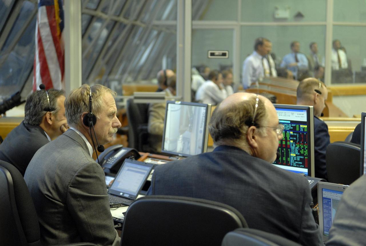 KENNEDY SPACE CENTER, FLA. --   In the Launch Control Center, William Gerstenmeier (left), associate administrator for NASA Space Operations Mission, and Wayne Hale, shuttle program manager,  monitor proceedings before the launch of Space Shuttle Atlantis on mission STS-117 to the International Space Station.  Liftoff from Launch Pad 39A was on-time at 7:38:04 p.m. EDT.  The shuttle is delivering a new segment to the starboard side of the International Space Station's backbone, known as the truss. Three spacewalks are planned to install the S3/S4 truss segment, deploy a set of solar arrays and prepare them for operation. STS-117 is the 118th space shuttle flight, the 21st flight to the station, the 28th flight for Atlantis and the first of four flights planned for 2007.   Photo credit: NASA/Kim Shiflett