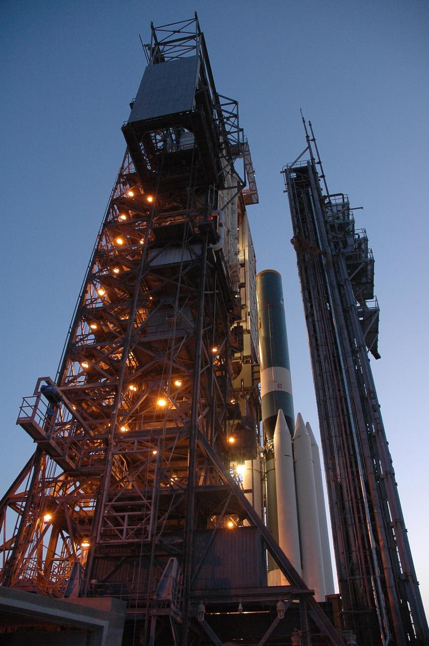 KENNEDY SPACE CENTER, FLA. -- Next to the mobile service tower on Launch Pad 17-B at Cape Canaveral Air Force Station, the Delta II first stage is being mated to the solid rocket boosters for launch of the Dawn spacecraft.  Dawn's goal is to characterize the conditions and processes of the solar system's earliest epoch 4.5 billion years ago by investigating in detail two of the largest asteroids, Ceres and Vesta. They reside between Mars and Jupiter in the asteroid belt.  Launch is targeted for July 7.  Photo credit: NASA/Jim Grossmann