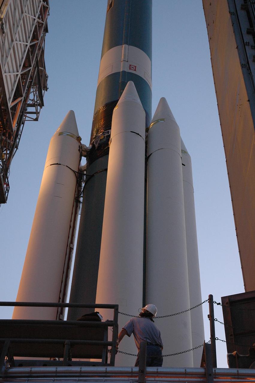 KENNEDY SPACE CENTER, FLA. -- This closeup shows four of the nine solid rocket boosters being mated to the Delta II first stage on Launch Pad 17-B at Cape Canaveral Air Force Station for launch of the Dawn spacecraft.  Dawn's goal is to characterize the conditions and processes of the solar system's earliest epoch 4.5 billion years ago by investigating in detail two of the largest asteroids, Ceres and Vesta. They reside between Mars and Jupiter in the asteroid belt.  Launch is targeted for July 7.  Photo credit: NASA/Jim Grossmann