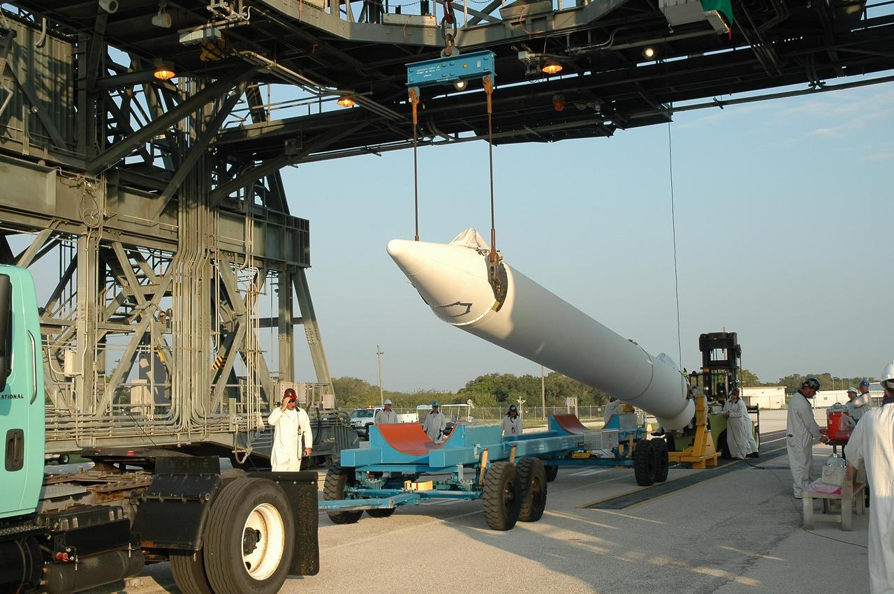 KENNEDY SPACE CENTER, FLA. -- A solid rocket booster is raised off its transporter before being lifted into the mobile service tower on Launch Pad 17-B at Cape Canaveral Air Force Station.  The booster will be mated to the Delta II first stage for launch of the Dawn spacecraft. Dawn's goal is to characterize the conditions and processes of the solar system's earliest epoch 4.5 billion years ago by investigating in detail two of the largest asteroids, Ceres and Vesta. They reside between Mars and Jupiter in the asteroid belt.  Launch is targeted for July 7.  Photo credit: NASA/Jim Grossmann