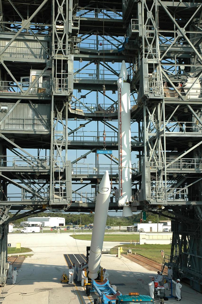KENNEDY SPACE CENTER, FLA. -- Another solid rocket booster is raised off its transporter before being lifted into the mobile service tower on Launch Pad 17-B at Cape Canaveral Air Force Station.  The booster will join the other suspended in the tower to be mated to the Delta II first stage for launch of the Dawn spacecraft.  Dawn's goal is to characterize the conditions and processes of the solar system's earliest epoch 4.5 billion years ago by investigating in detail two of the largest asteroids, Ceres and Vesta. They reside between Mars and Jupiter in the asteroid belt.  Launch is targeted for July 7.  Photo credit: NASA/Jim Grossmann
