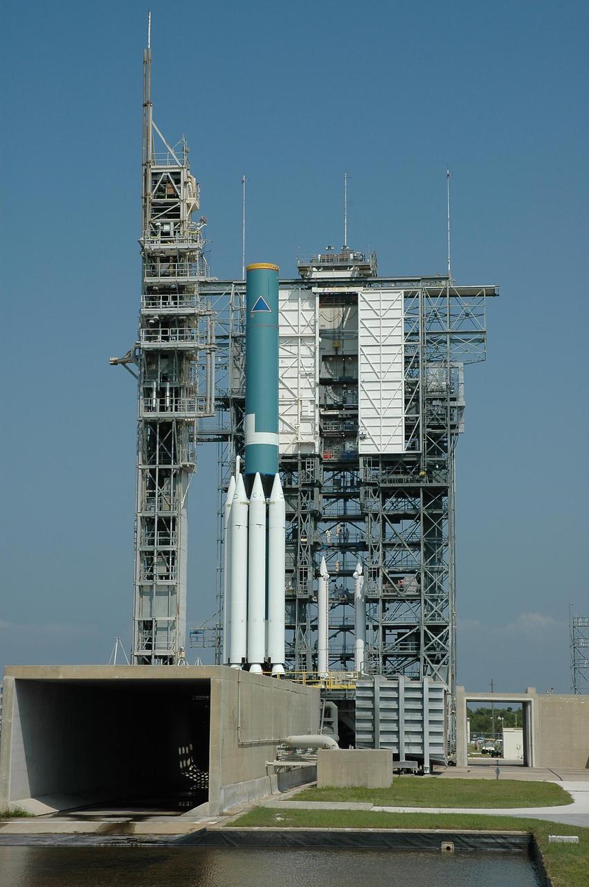 KENNEDY SPACE CENTER, FLA. --  On Launch Pad 17-B at Cape Canaveral Air Force Station, the Delta II first stage at left waits for additional solid rocket boosters in the mobile service tower to be mated with those already attached.  The Delta is the launch vehicle of the Dawn spacecraft.  Dawn's goal is to characterize the conditions and processes of the solar system's earliest epoch 4.5 billion years ago by investigating in detail two of the largest asteroids, Ceres and Vesta. They reside between Mars and Jupiter in the asteroid belt.  Launch is targeted for July 7.  Photo credit: NASA/Jim Grossmann