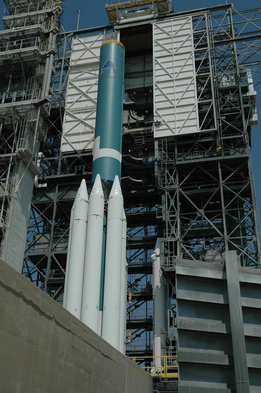 KENNEDY SPACE CENTER, FLA. --  On Launch Pad 17-B at Cape Canaveral Air Force Station, the mobile service tower with solid rocket boosters inside nears the Delta II first stage. The Delta is the launch vehicle of the Dawn spacecraft.  Dawn's goal is to characterize the conditions and processes of the solar system's earliest epoch 4.5 billion years ago by investigating in detail two of the largest asteroids, Ceres and Vesta. They reside between Mars and Jupiter in the asteroid belt.  Launch is targeted for July 7.  Photo credit: NASA/Jim Grossmann